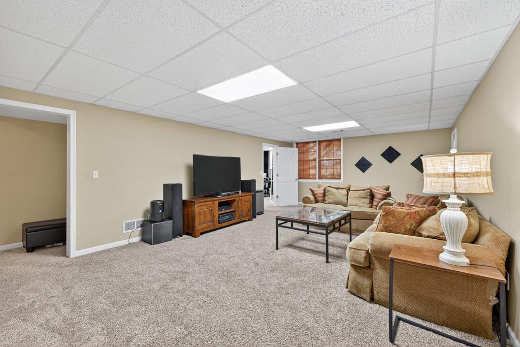 1430 Roanoke Trace Grayson, GA 30017 - Photo 39 of 62 a living room with furniture and a flat screen tv