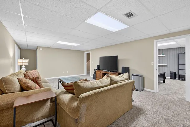 a view of a patio with table and chairs with wooden floor and fence