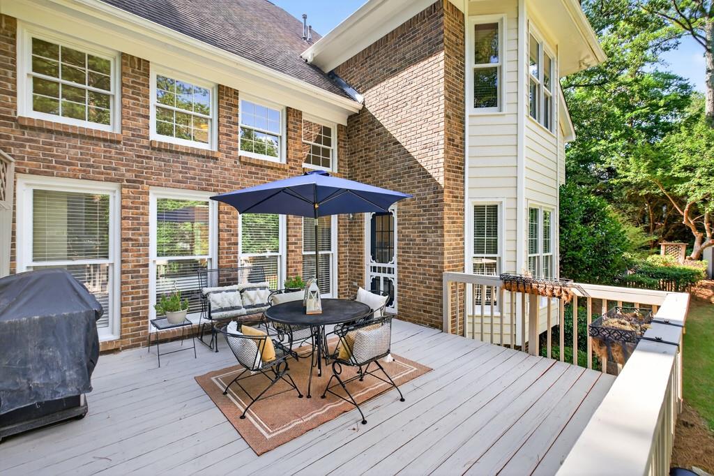 1430 Roanoke Trace Grayson, GA 30017 - Photo 48 of 62 a view of a patio with a table and chairs under an umbrella