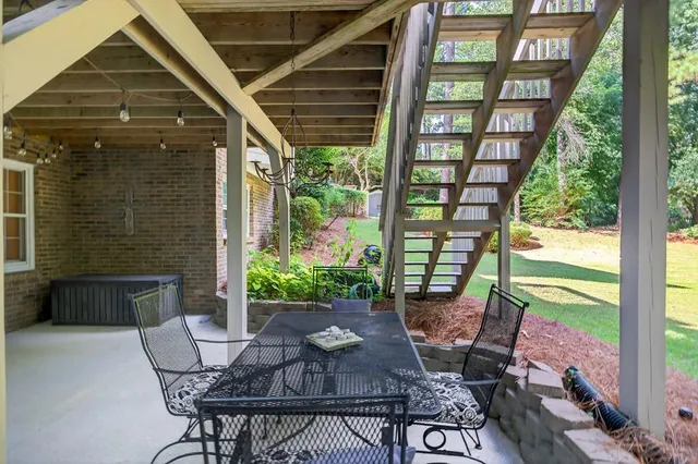 an aerial view of a house with garden space and trees