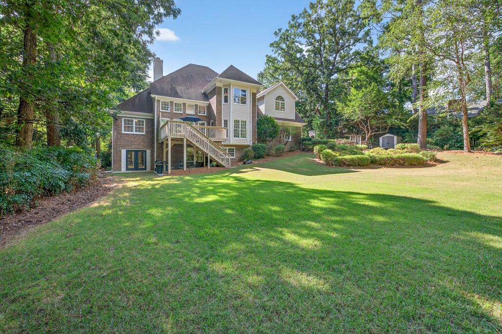 1430 Roanoke Trace Grayson, GA 30017 - Photo 52 of 62 a view of a house with a big yard and large trees