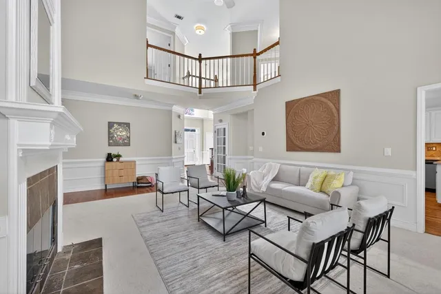 a living room with furniture a flat screen tv and a fireplace
