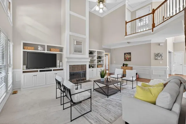 a kitchen with stainless steel appliances granite countertop a refrigerator a sink dishwasher a stove and white countertops with wooden floor