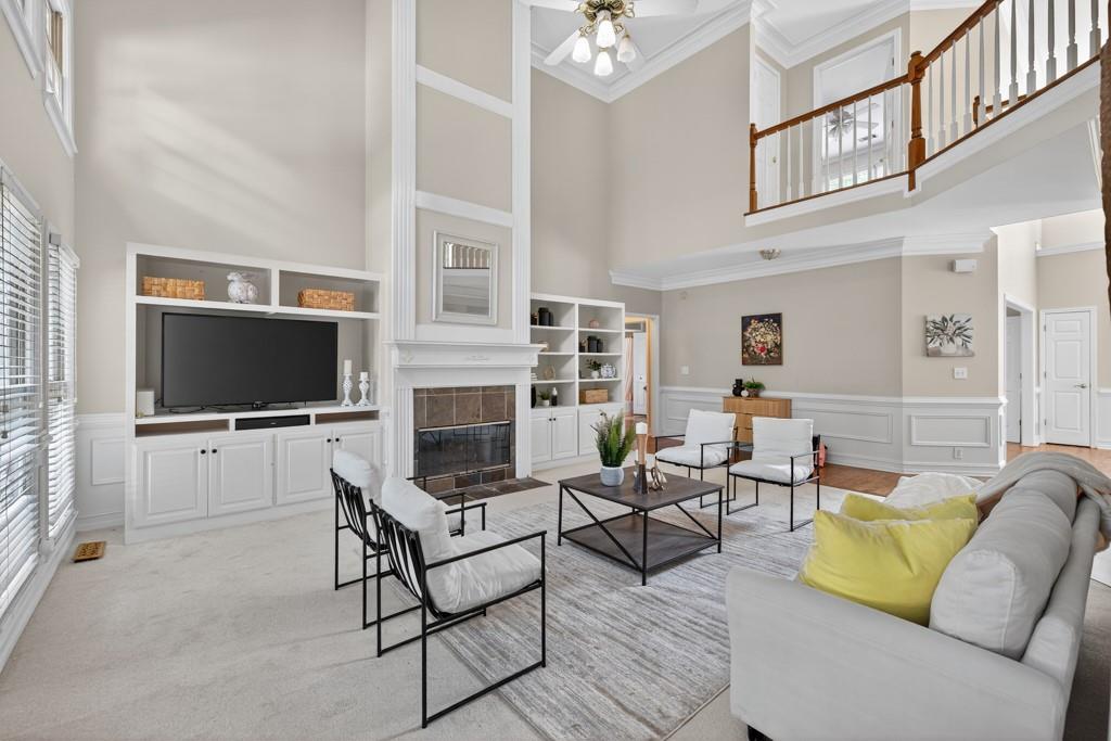 1430 Roanoke Trace Grayson, GA 30017 - Photo 9 of 62 a living room with furniture a flat screen tv and a fireplace