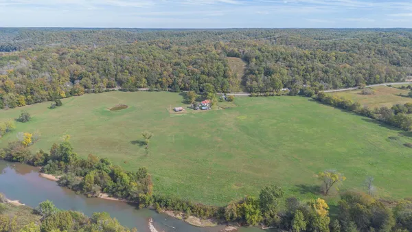 a view of a field with an ocean