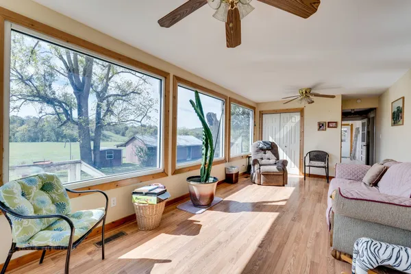 a living room with furniture and a floor to ceiling window
