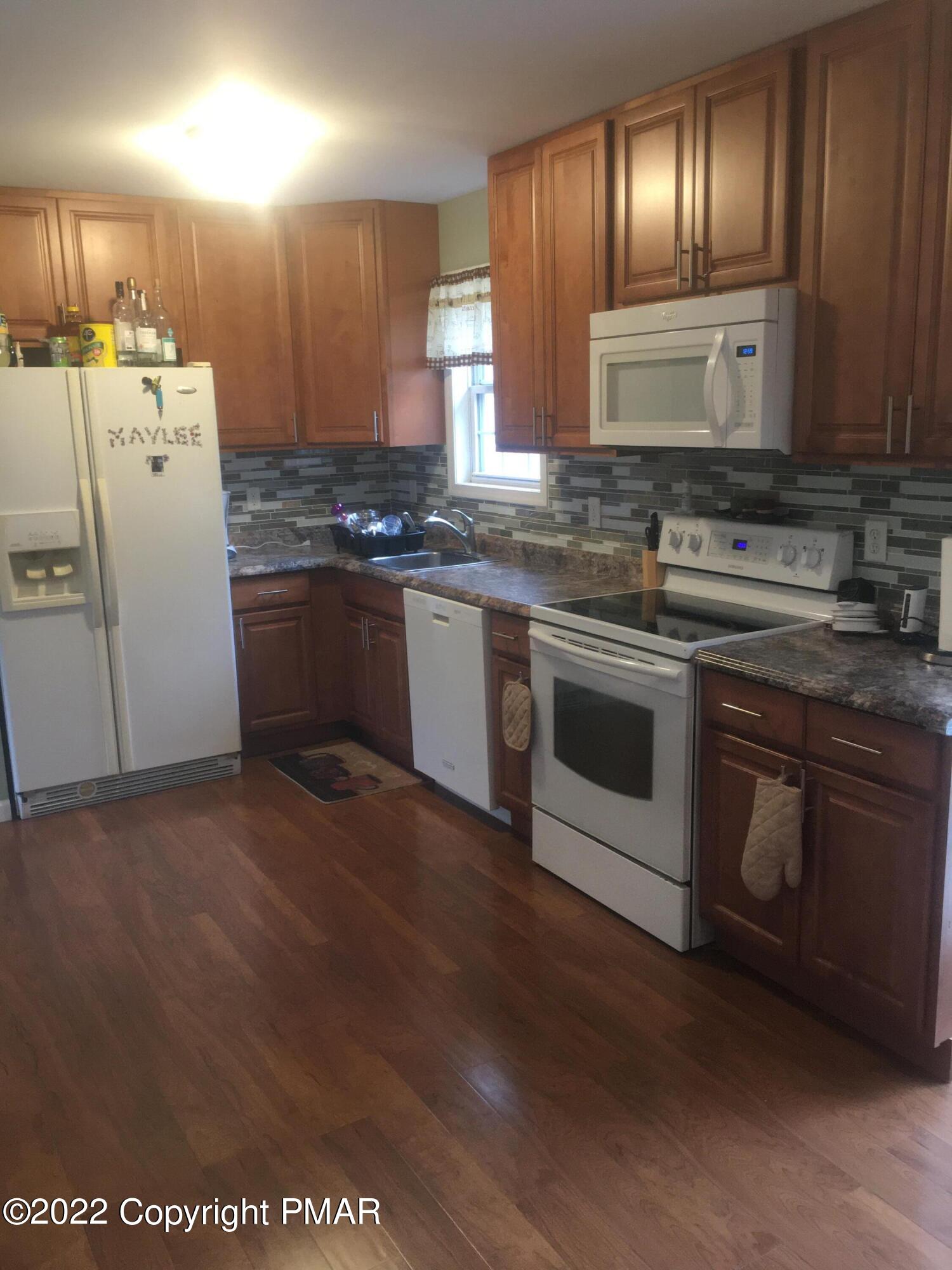 177 Granite Road Long Pond, PA 18334 - Photo 7 of 16 a kitchen with a sink and refrigerator