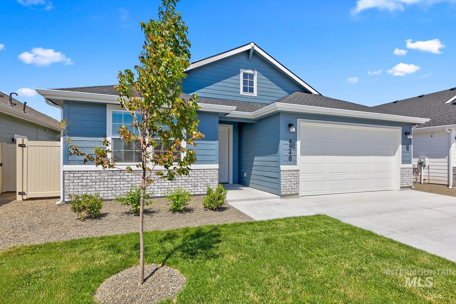 4548 West Wapoot Street Meridian, ID 83646 - Photo 1 of 17 Light blue siding exterior featuring white trim and a contrasting light gray brick facade