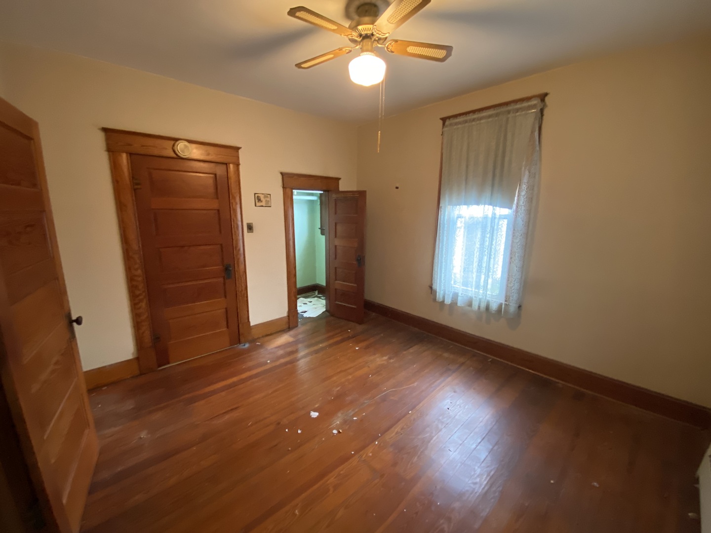 210 Rolston Street Centralia, IL 62801 - Photo 4 of 9 wooden floor in an empty room with a window