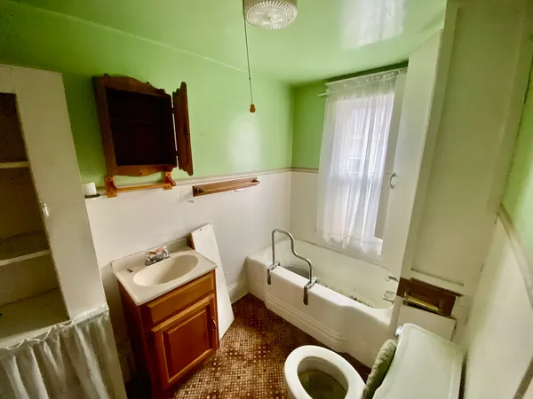 a bathroom with a sink toilet and mirror