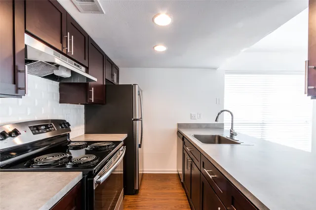 a kitchen that has a sink and a stove