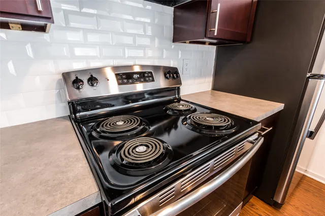 a stove top oven sitting inside of a kitchen