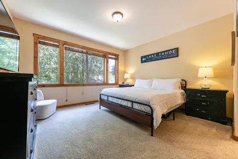 a spacious bedroom with a bed and a large window