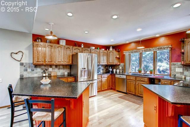 3210 Arena Road Colorado Springs, CO 80921 - Photo 3 of 19 Beautiful large newly updated kitchen with granite slab counters, high-end appliances, breakfast bar, and hardwood floors. A gourmet's delight!