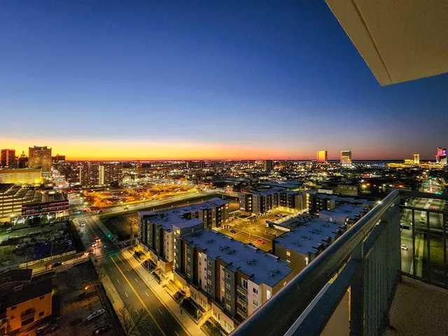 a city street filled with lots of traffic and tall trees