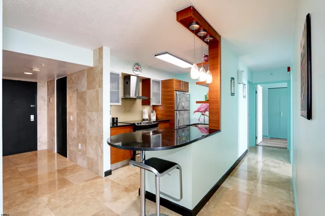 a view of living room kitchen and entryway