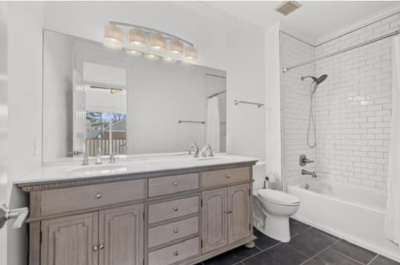 1687 Kimbrough Road, Unit 1687 Germantown, TN 38138 - Photo 11 of 20 a bathroom with a granite countertop toilet a double vanity sink a mirror and a bathtub