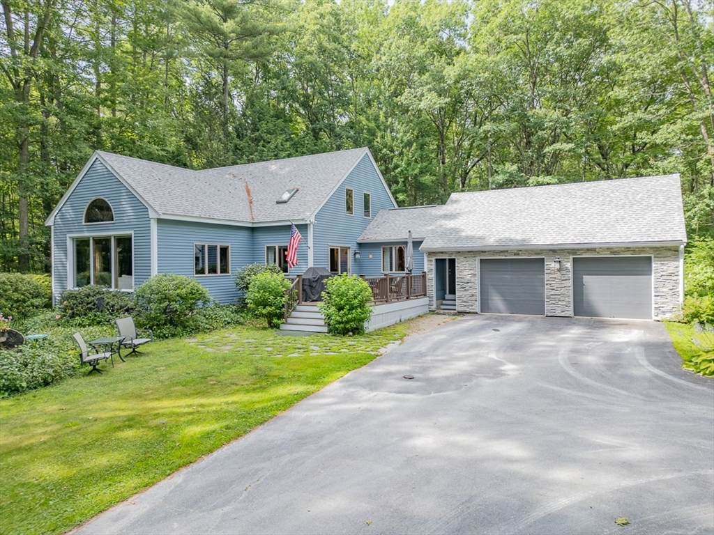 a front view of a house with a garden and yard