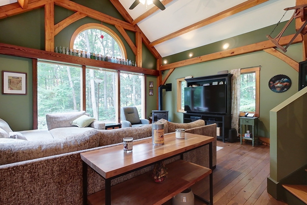 23 A Heald Street Pepperell, MA 01463 - Photo 12 of 42 a living room with furniture a large window and a flat screen tv