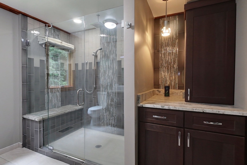 23 A Heald Street Pepperell, MA 01463 - Photo 20 of 42 a bathroom with a granite countertop sink mirror and shower