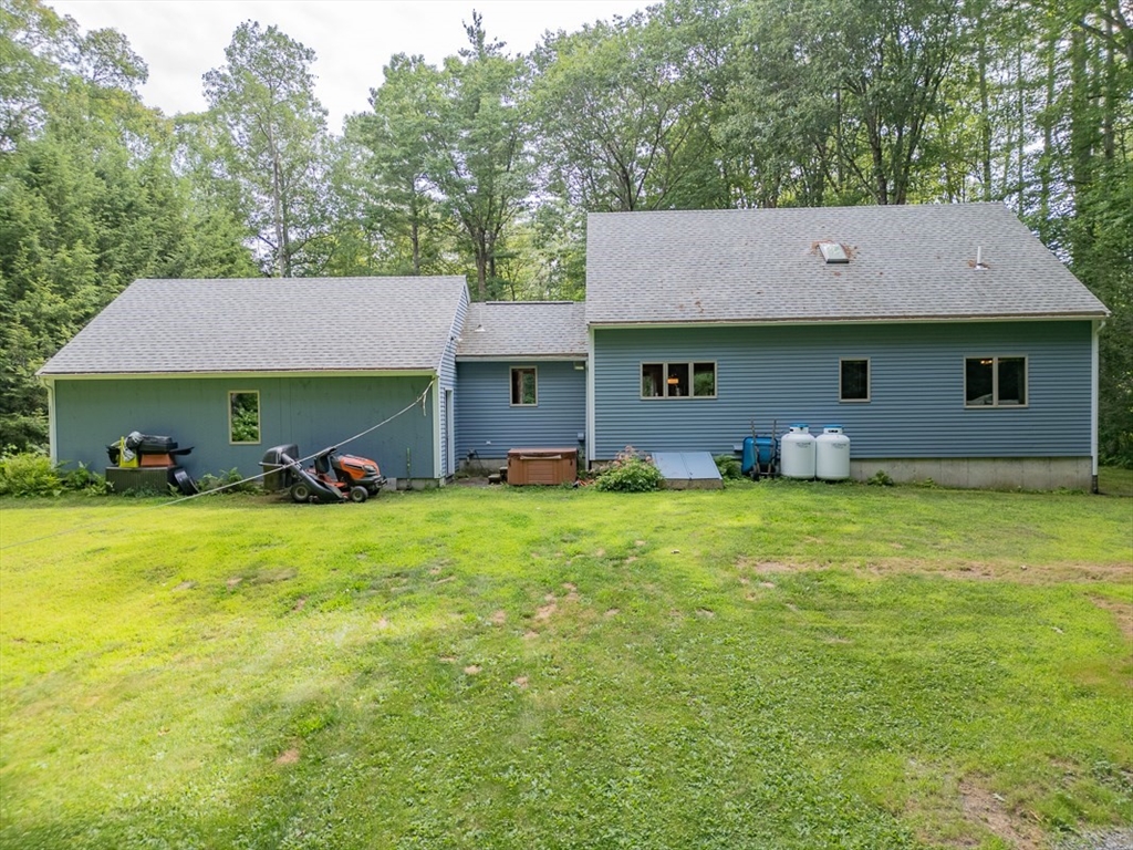 23 A Heald Street Pepperell, MA 01463 - Photo 2 of 42 a front view of a house with a garden
