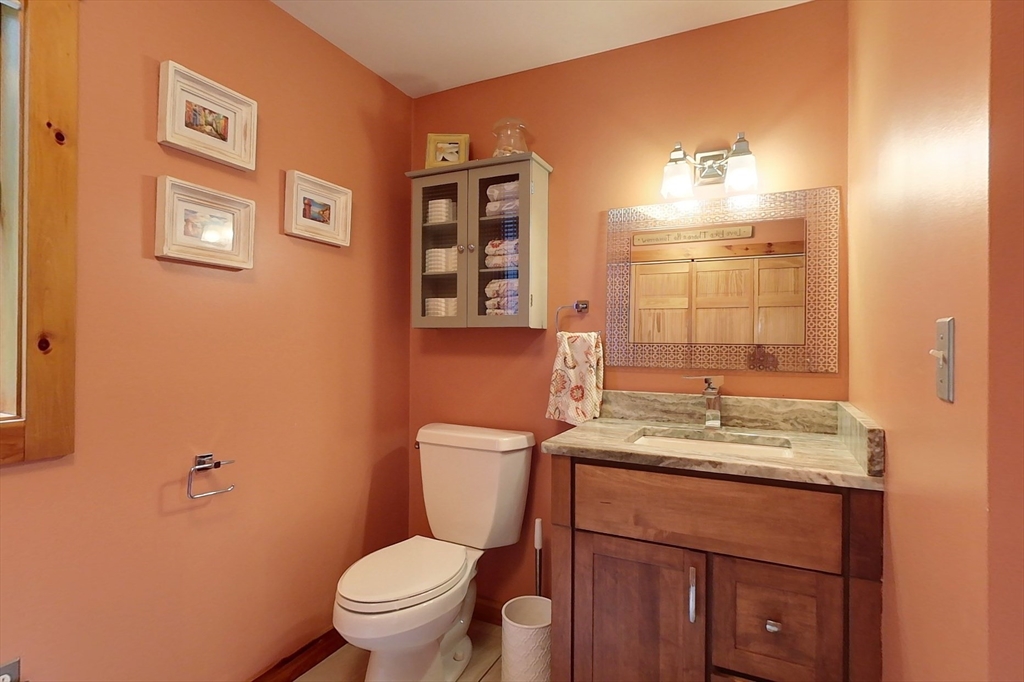 23 A Heald Street Pepperell, MA 01463 - Photo 21 of 42 a bathroom with a granite countertop toilet sink and mirror