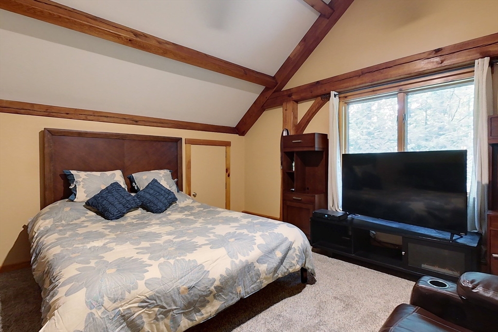 23 A Heald Street Pepperell, MA 01463 - Photo 22 of 42 a bedroom with a large bed and a flat screen tv