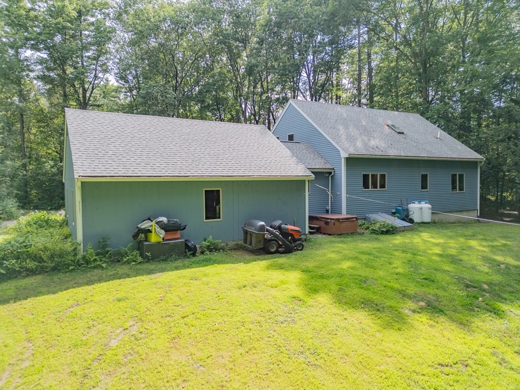 23 A Heald Street Pepperell, MA 01463 - Photo 30 of 42 a front view of a house with yard and trees
