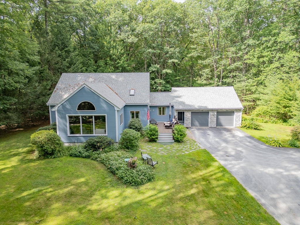 23 A Heald Street Pepperell, MA 01463 - Photo 34 of 42 a front view of a house with a yard and garage