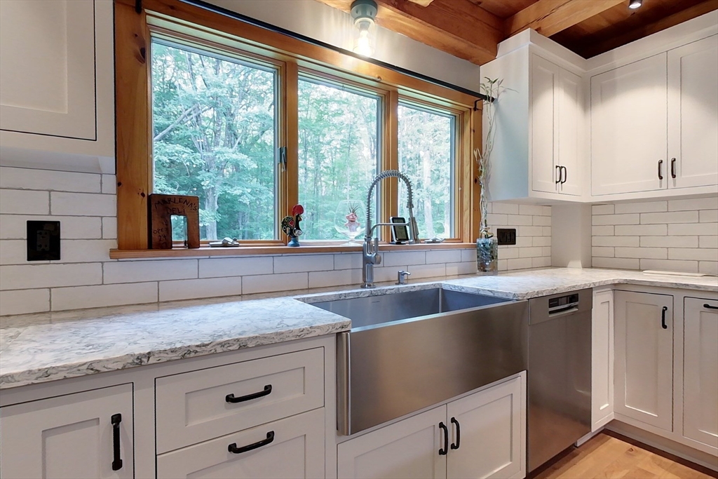 23 A Heald Street Pepperell, MA 01463 - Photo 4 of 42 a kitchen with granite countertop a sink and a window