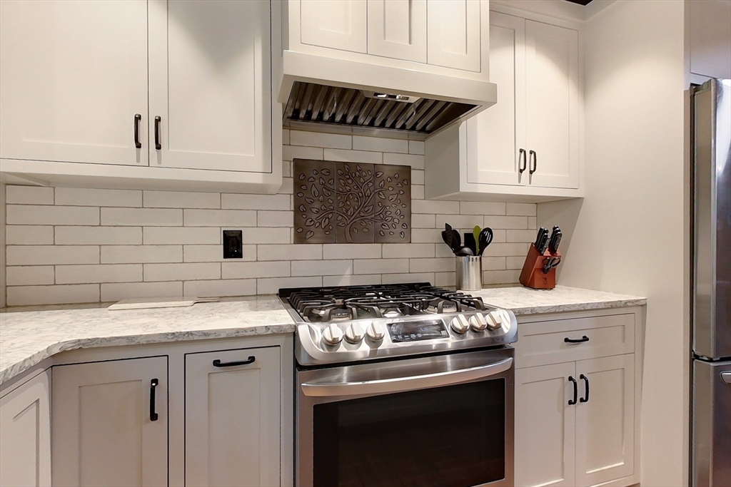 23 A Heald Street Pepperell, MA 01463 - Photo 5 of 42 a kitchen with granite countertop a stove sink and cabinets