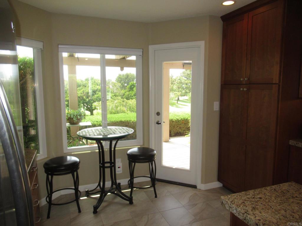 4913 Alicante Way Oceanside, CA 92056 - Photo 11 of 34 a dining room with furniture and a window