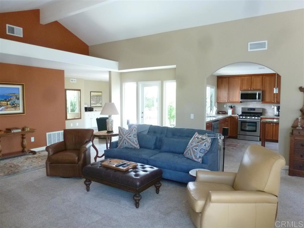 4913 Alicante Way Oceanside, CA 92056 - Photo 15 of 34 a living room with furniture fireplace and a window