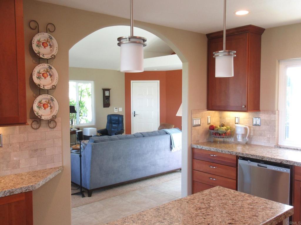 4913 Alicante Way Oceanside, CA 92056 - Photo 3 of 34 a living room with granite countertop furniture and a wooden floor