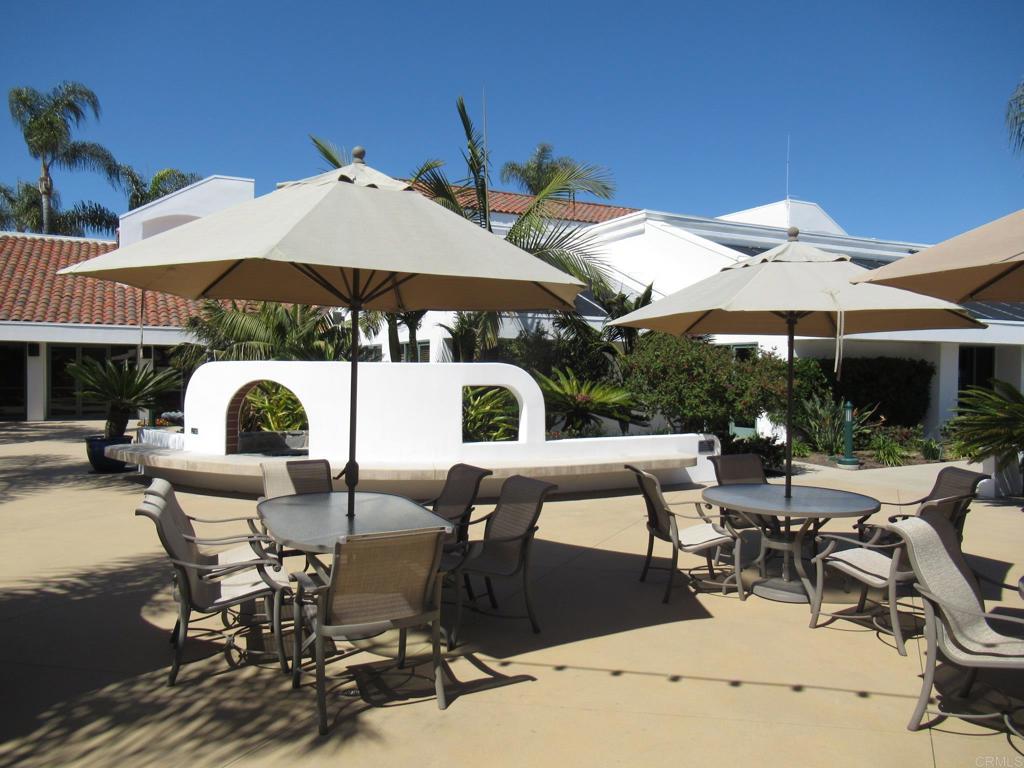 4913 Alicante Way Oceanside, CA 92056 - Photo 32 of 34 a view of a patio with table and chairs under an umbrella