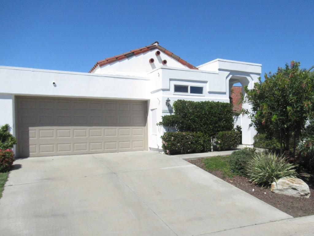 4913 Alicante Way Oceanside, CA 92056 - Photo 5 of 34 a front view of a house with a yard and garage