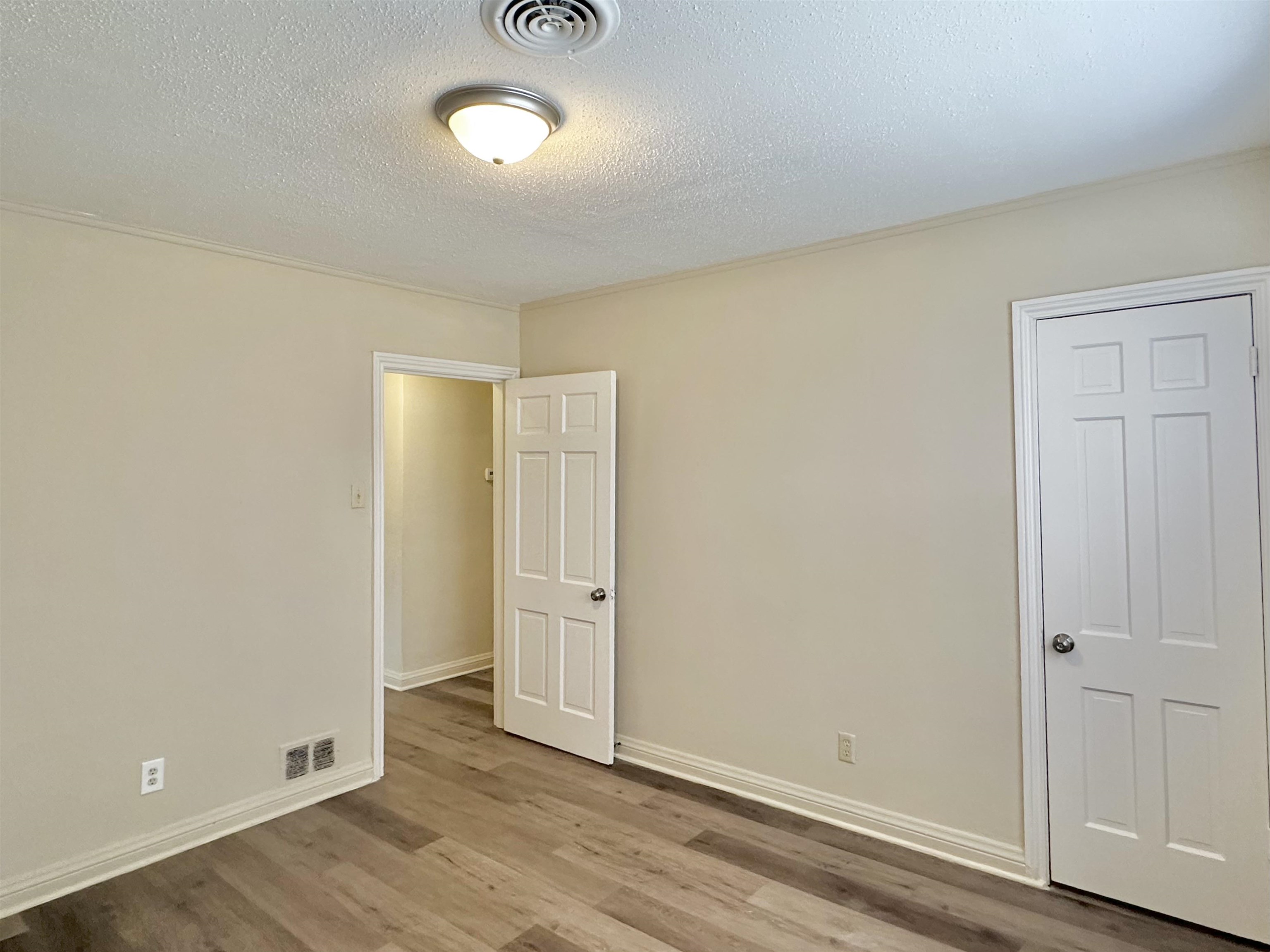2195 Carnes Avenue Memphis, TN 38114 - Photo 15 of 30 an empty room with wooden floor and windows