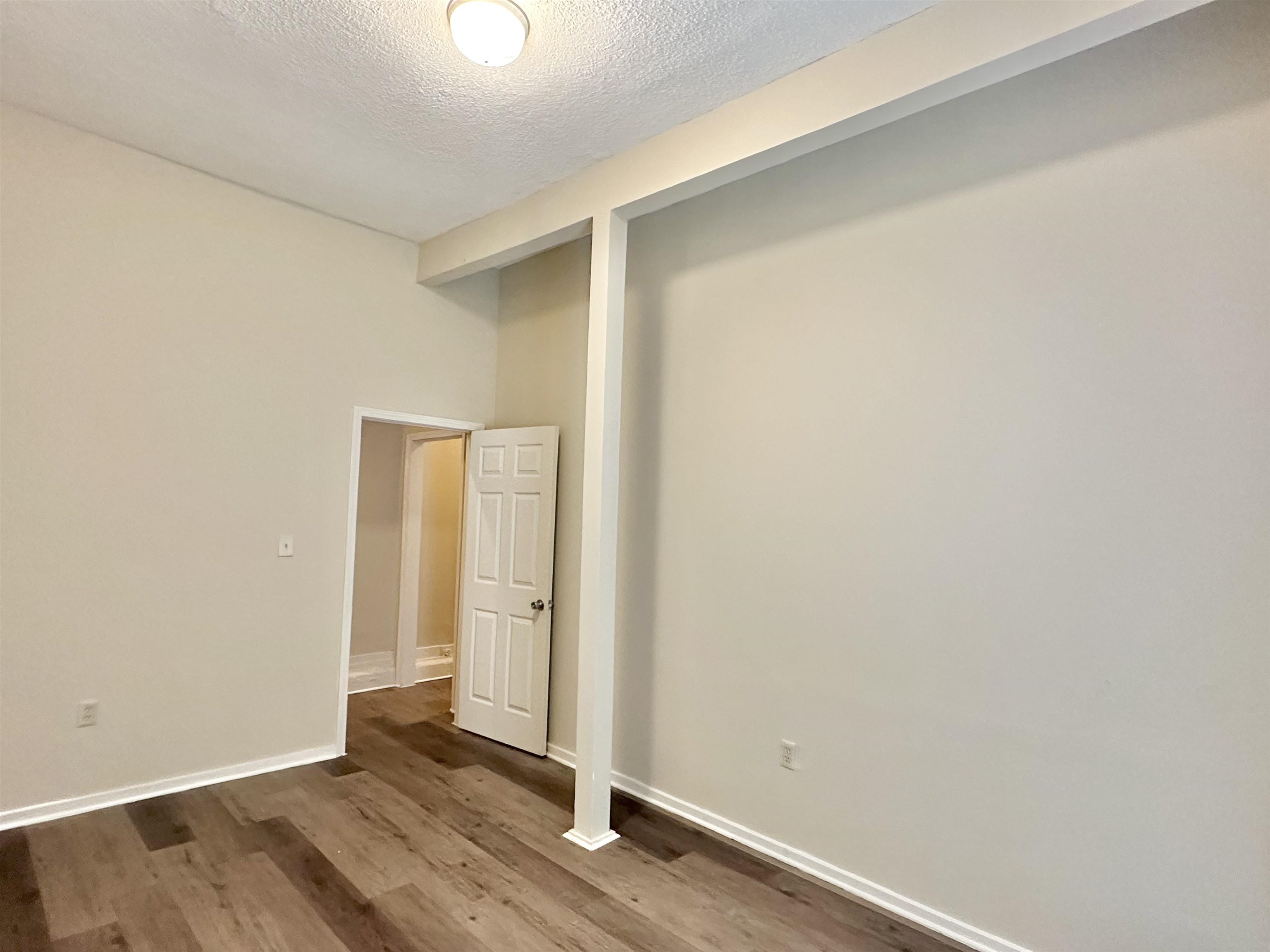 2195 Carnes Avenue Memphis, TN 38114 - Photo 18 of 30 an empty room with wooden floor and windows