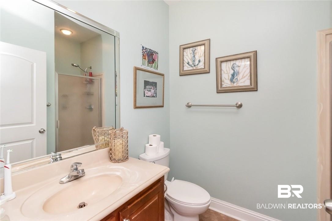7170 Pierson Drive Mobile, AL 36619 - Photo 16 of 29 Bathroom featuring toilet, vanity, and an enclosed shower