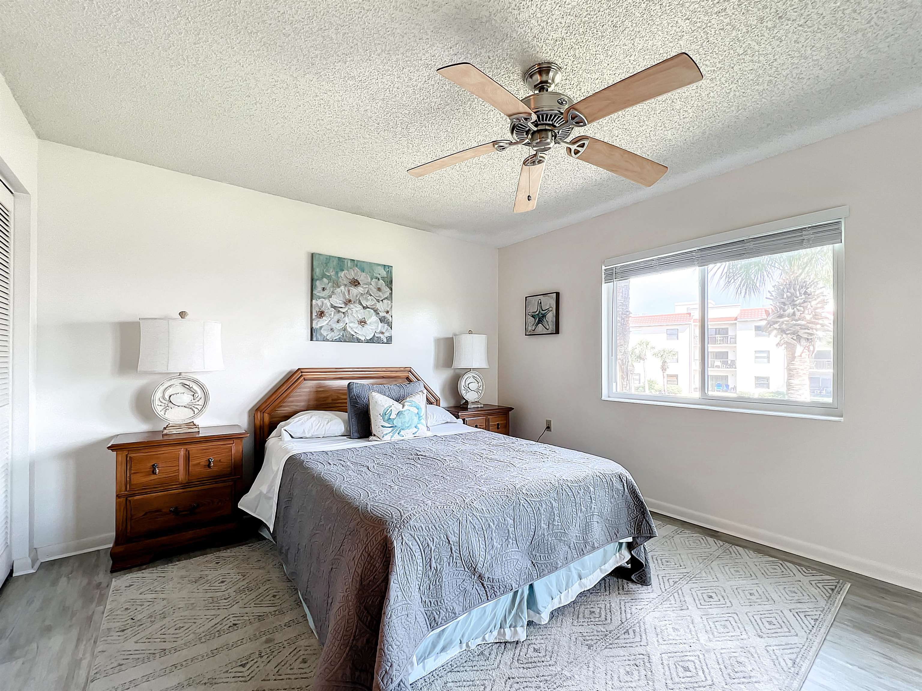 4250 A1A South, Unit O23 St. Augustine, FL 32080 - Photo 14 of 38 a bedroom with a bed and a chandelier