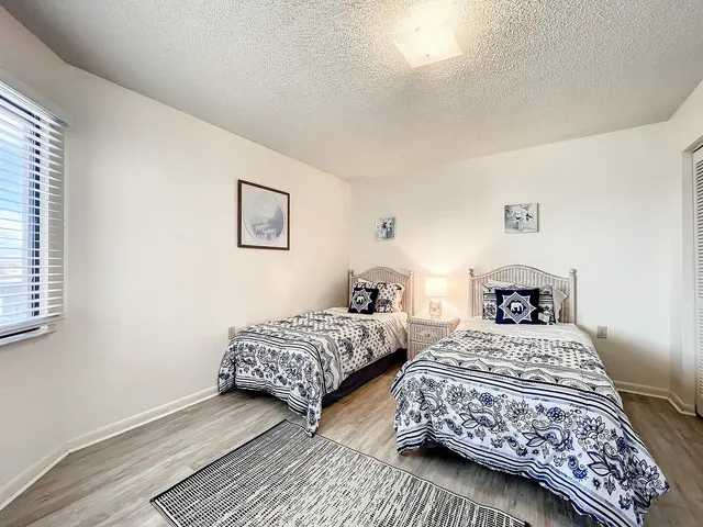 a bedroom with two beds and a lamp