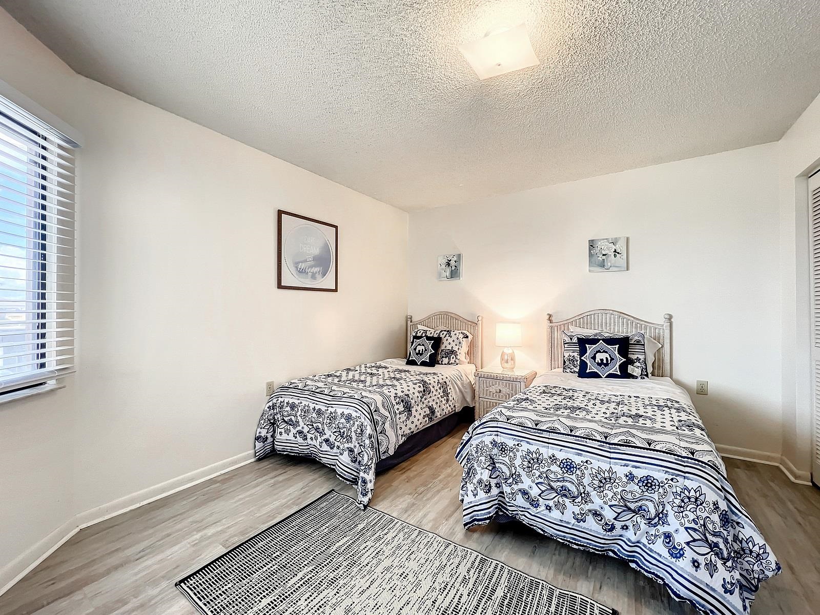 4250 A1A South, Unit O23 St. Augustine, FL 32080 - Photo 17 of 38 a bedroom with two beds and a lamp
