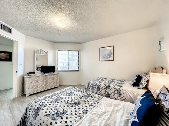 a bedroom with a bed and a couch