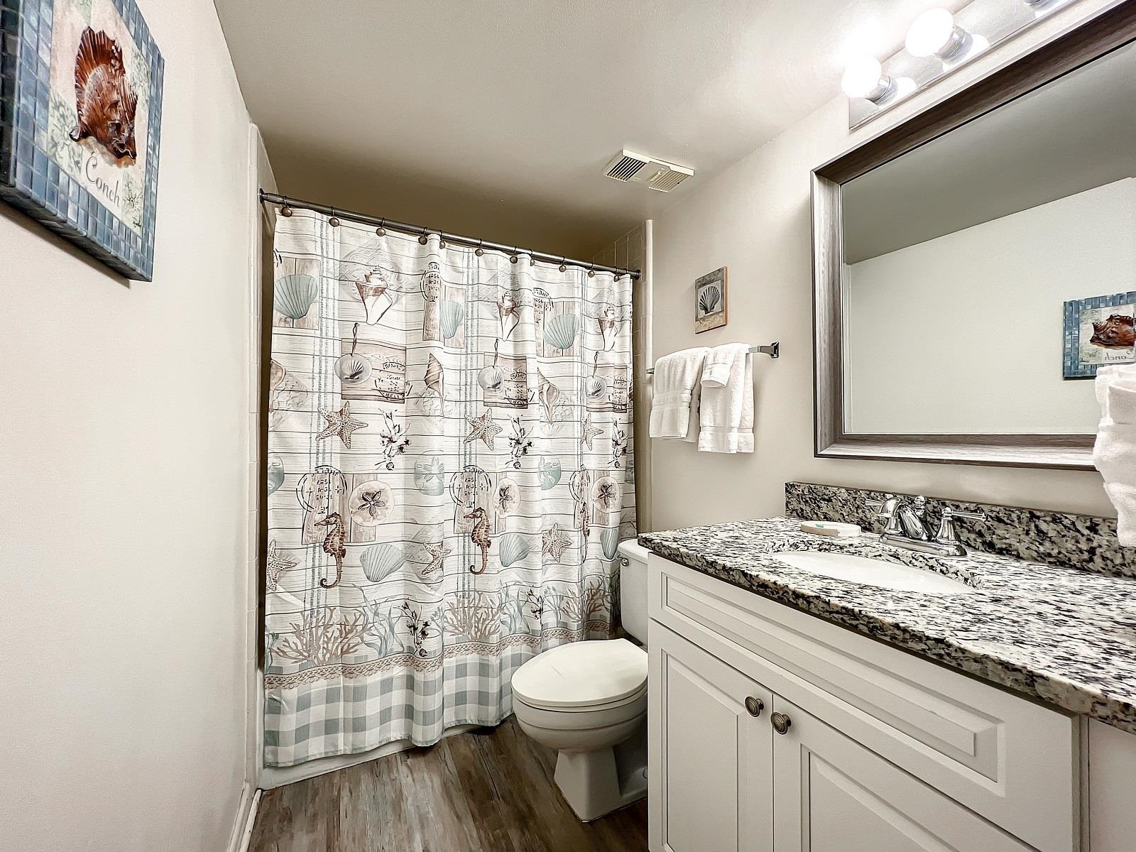 4250 A1A South, Unit O23 St. Augustine, FL 32080 - Photo 19 of 38 a bathroom with a granite countertop sink toilet and shower