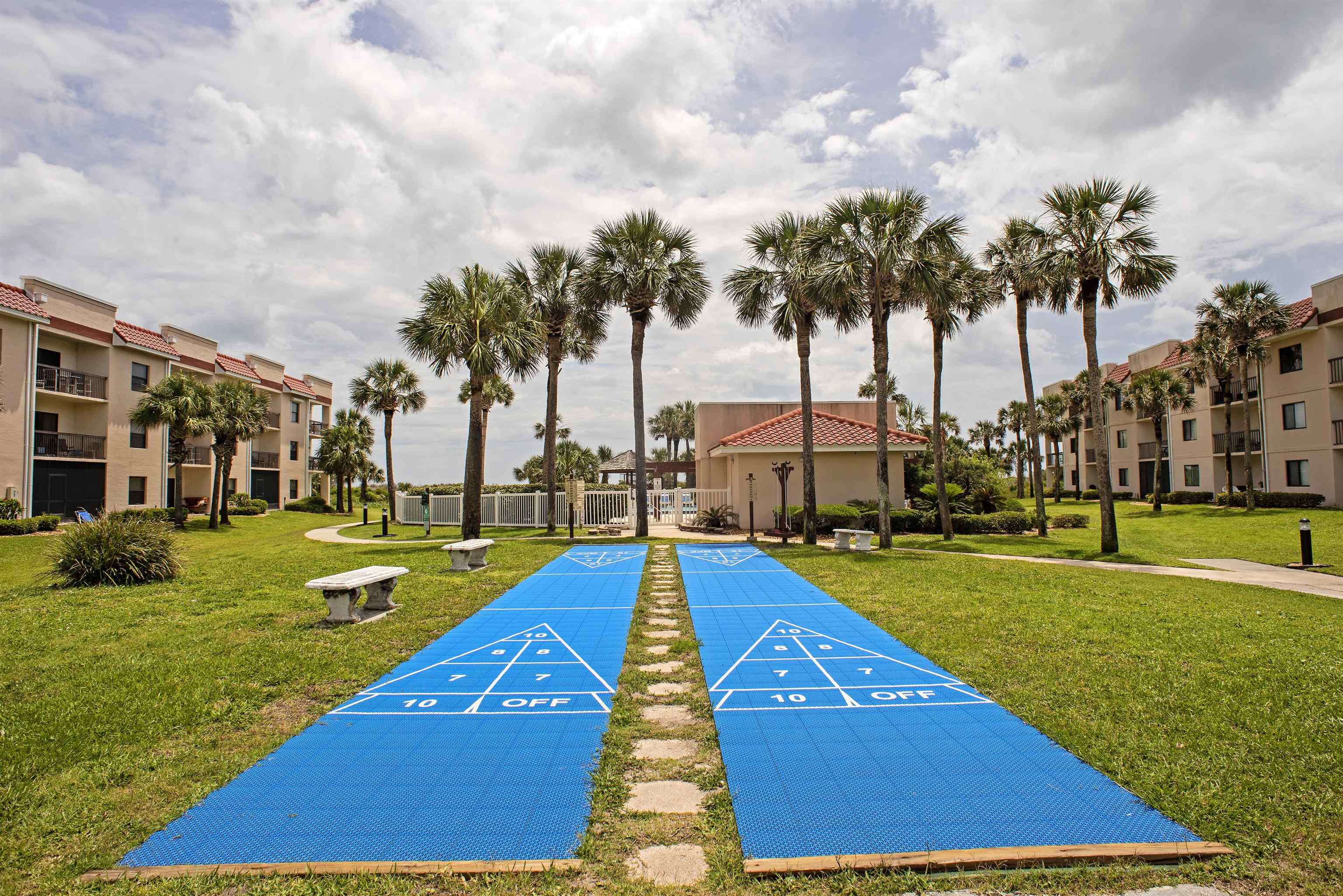 4250 A1A South, Unit O23 St. Augustine, FL 32080 - Photo 23 of 38 a view of swimming pool with lawn chairs and palm trees