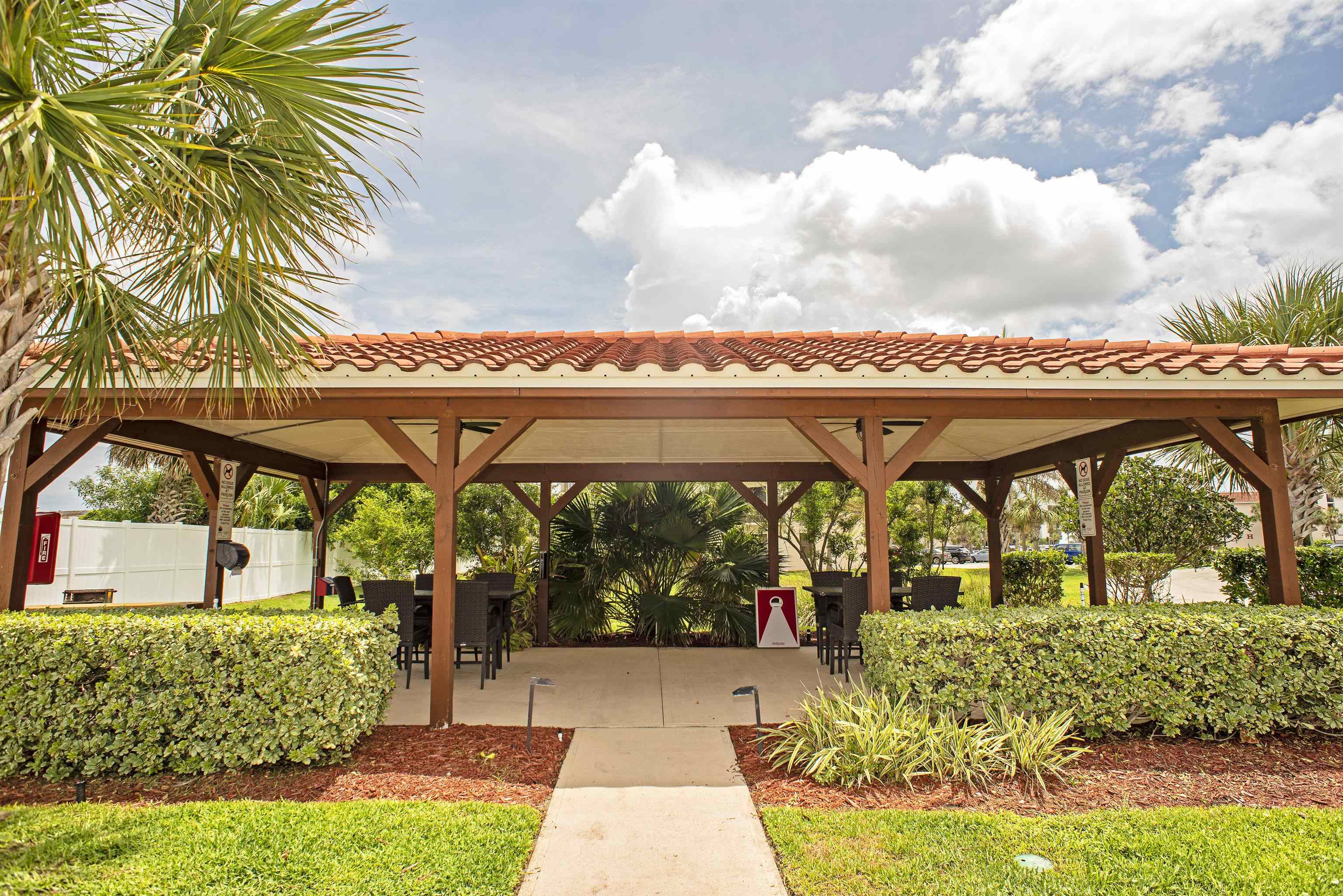 4250 A1A South, Unit O23 St. Augustine, FL 32080 - Photo 28 of 38 a view of a patio with a table and chairs under an umbrella