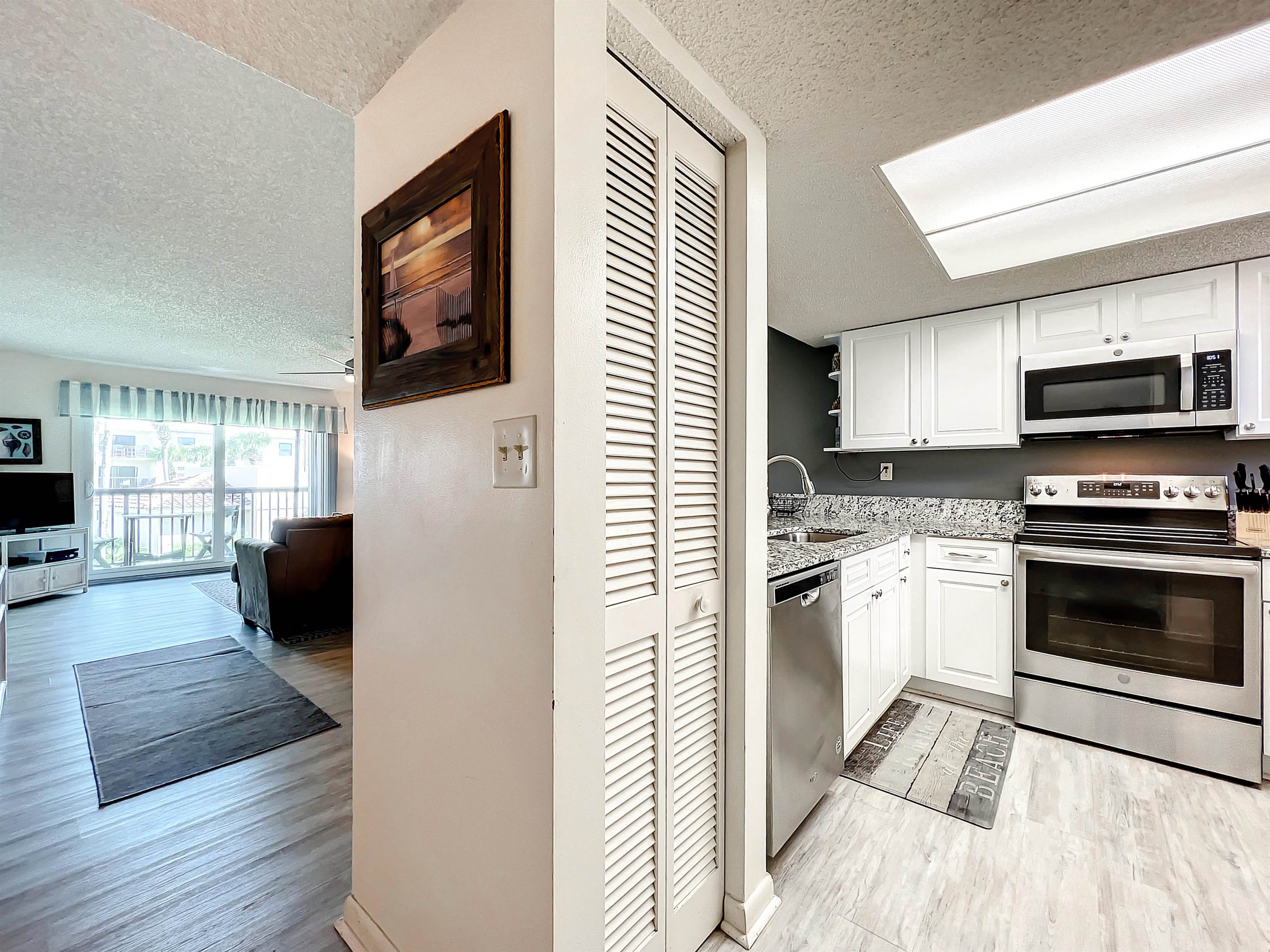 4250 A1A South, Unit O23 St. Augustine, FL 32080 - Photo 5 of 38 a kitchen with granite countertop a refrigerator and a stove top oven