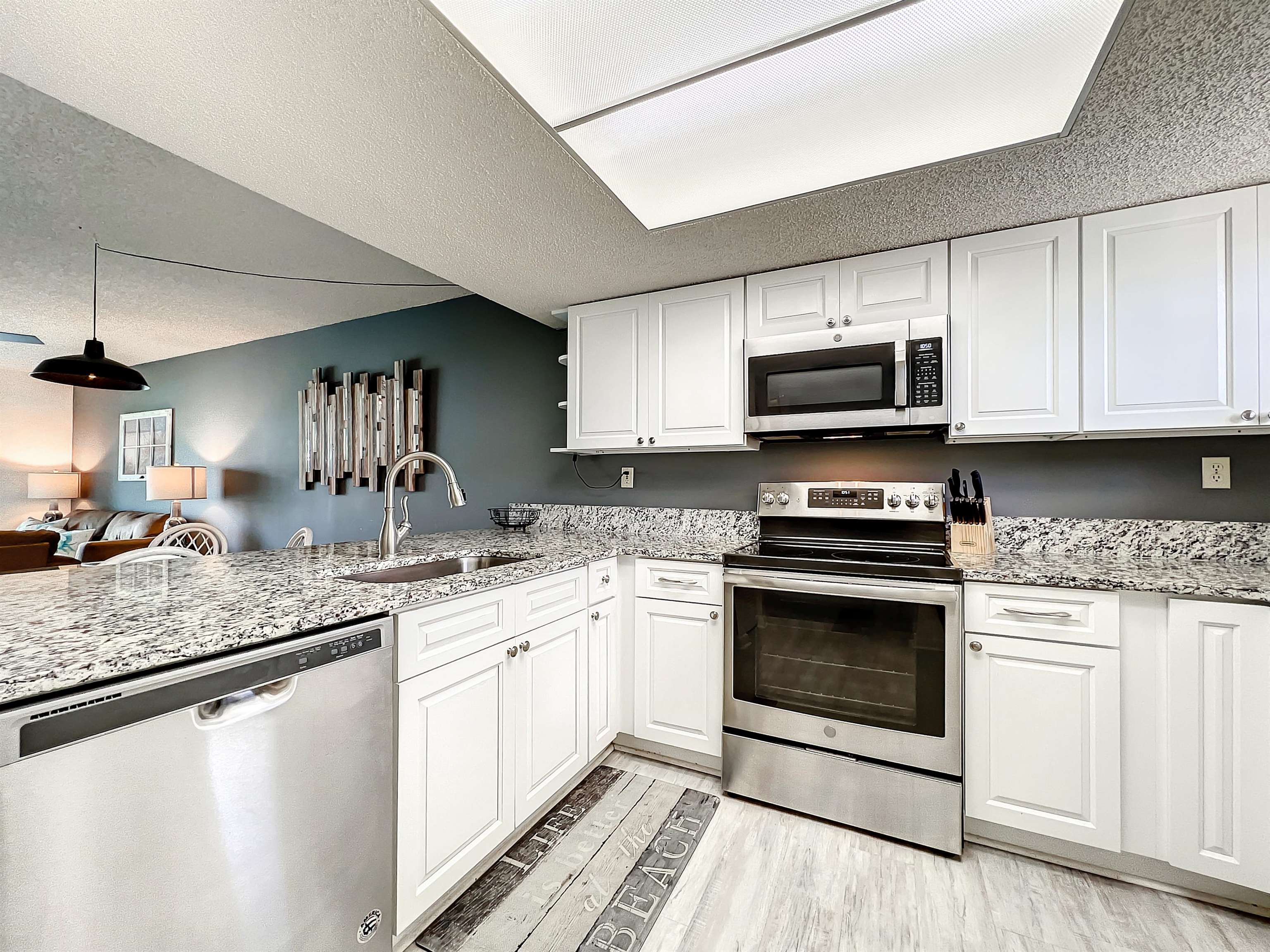 4250 A1A South, Unit O23 St. Augustine, FL 32080 - Photo 6 of 38 a kitchen with stainless steel appliances granite countertop a sink stove and microwave