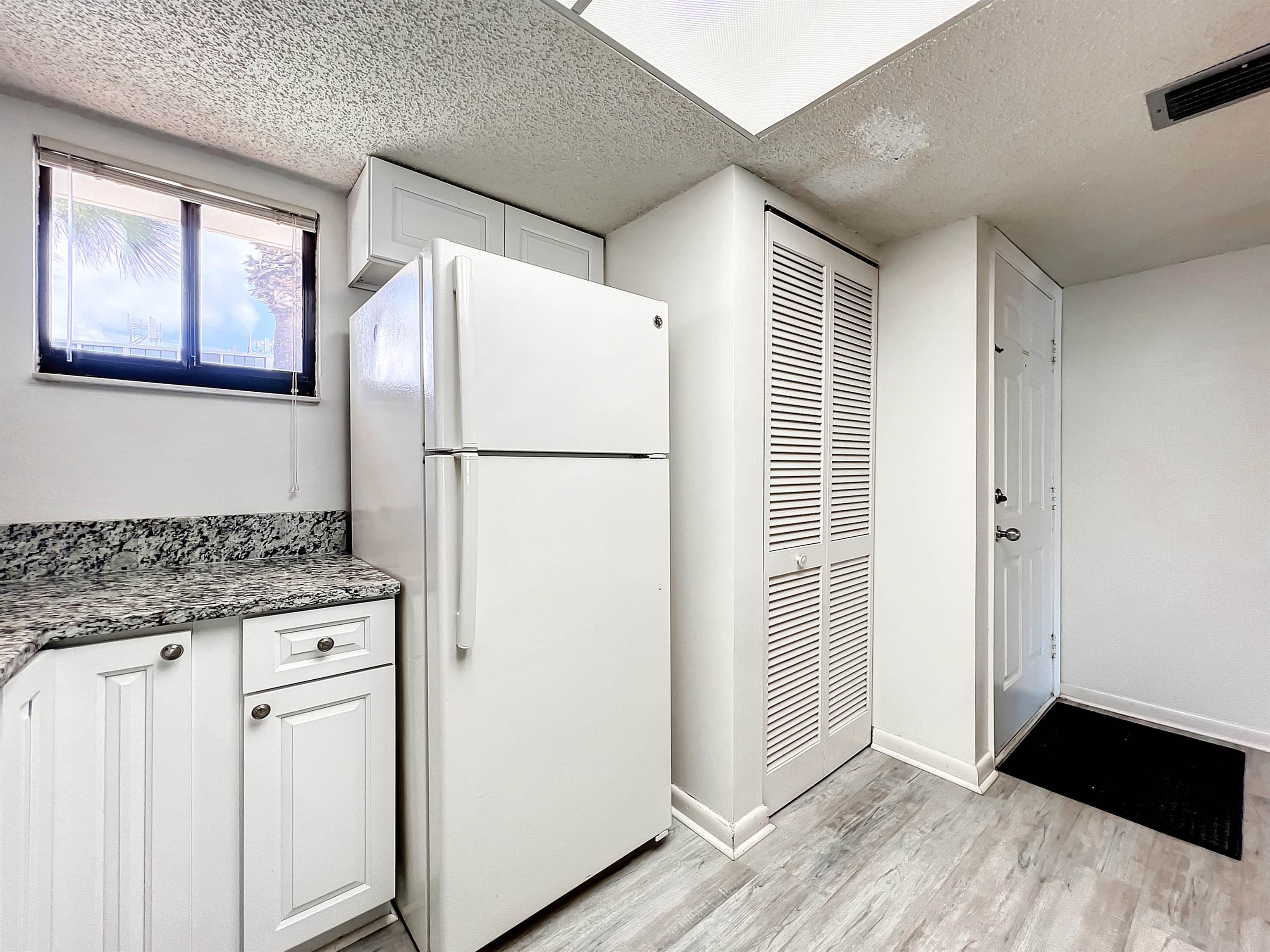 4250 A1A South, Unit O23 St. Augustine, FL 32080 - Photo 7 of 38 a kitchen with a refrigerator a stove top oven and a refrigerator