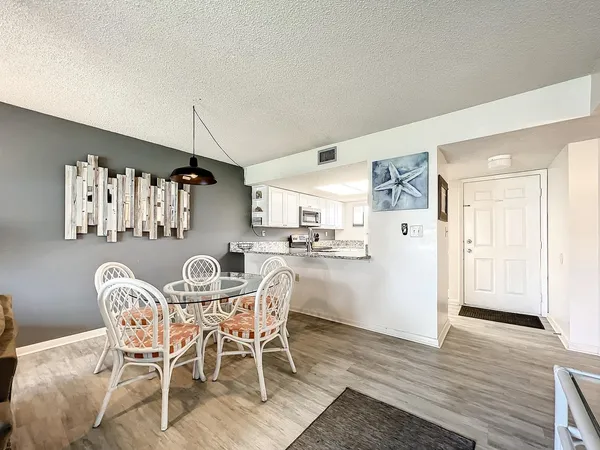 a view of a dining room with furniture and wooden floor